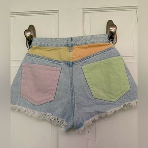 Pacsun Shorts. Multicolored pockets, on light jean shorts.